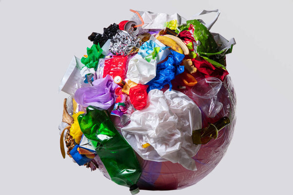 A globe of the earth with trash over white background, the concept of ecology problem
