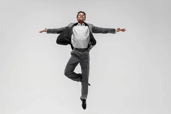 Happy businessman dancing isolated on gray studio background — Stock Photo, Image