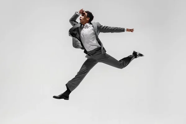 Happy businessman dancing isolated on gray studio background — Stock Photo, Image