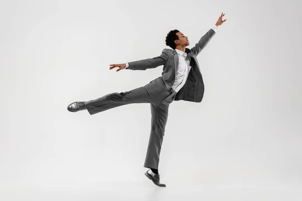 Happy businessman dancing isolated on gray studio background — Stock Photo, Image