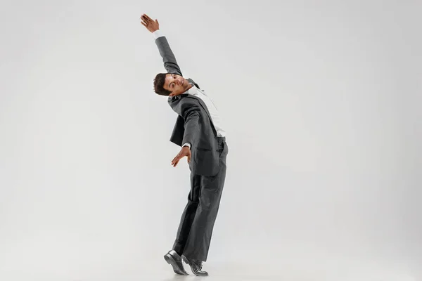 Happy businessman dancing isolated on gray studio background — Stock Photo, Image