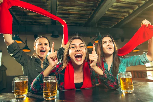 Concept de sport, de personnes, de loisirs, d'amitié et de divertissement - fans de football heureux ou amies buvant de la bière et célébrant la victoire au bar ou au pub — Photo