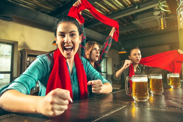 Concept de sport, de personnes, de loisirs, d'amitié et de divertissement - fans de football heureux ou amies buvant de la bière et célébrant la victoire au bar ou au pub — Photo