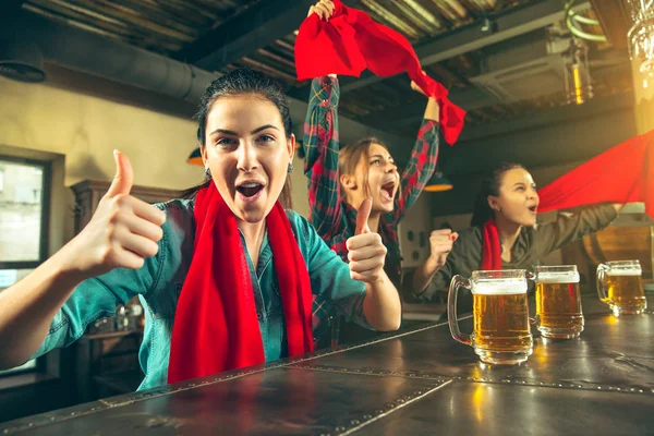 Concept de sport, de personnes, de loisirs, d'amitié et de divertissement - fans de football heureux ou amies buvant de la bière et célébrant la victoire au bar ou au pub — Photo