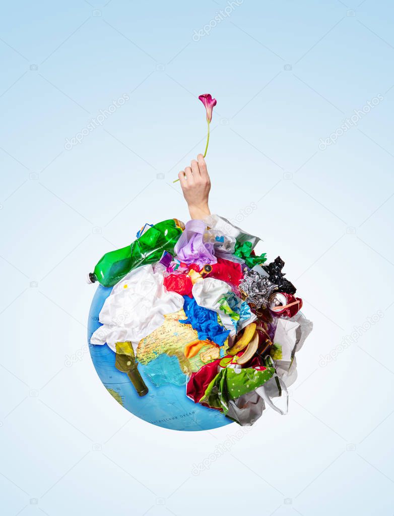 A globe of the earth with trash over white background, the concept of ecology problem