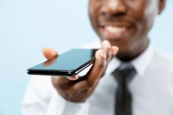 Портрет привабливого молодого чорношкірого чоловіка, який тримає порожній смартфон — стокове фото