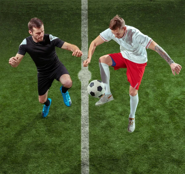 Football players tackling ball over green grass background