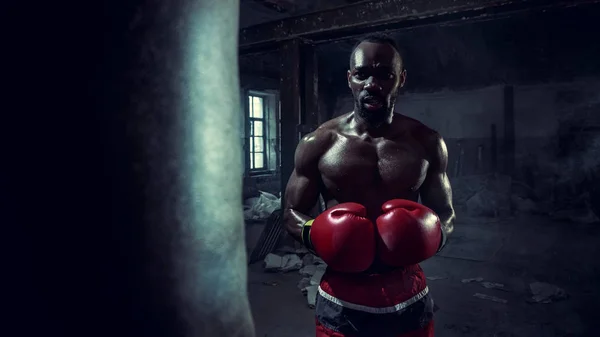 Hand of boxer over black background. Strength, attack and motion concept — Stock Photo, Image