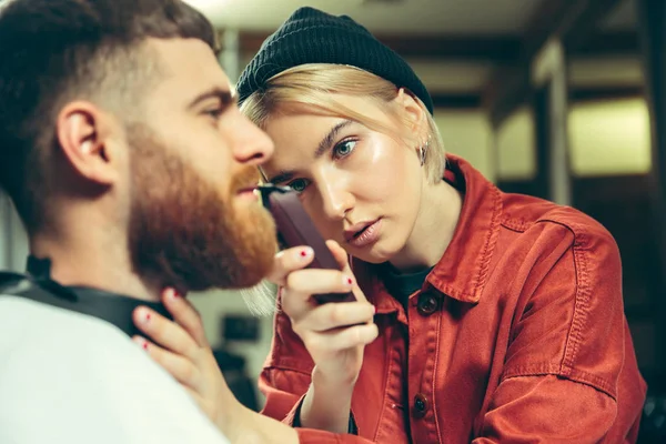 Client during beard shaving in barber shop