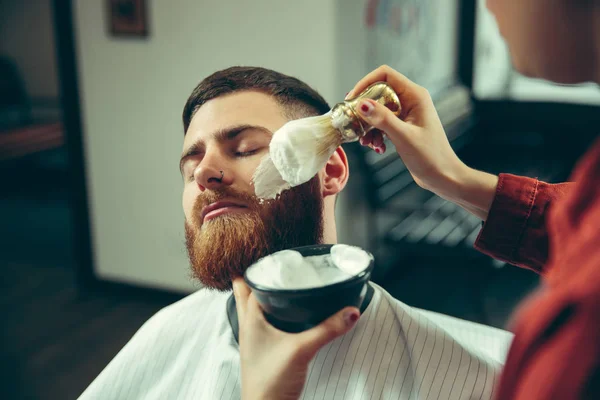 Client during beard shaving in barber shop — Stock Photo, Image