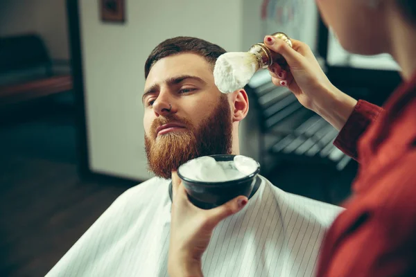 Client during beard shaving in barber shop — Stock Photo, Image