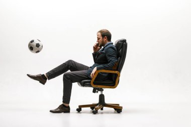 Ofisinde futbol topu olan bir iş adamı.