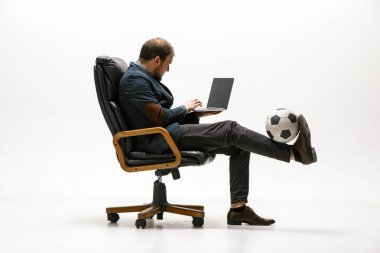Ofisinde futbol topu olan bir iş adamı.