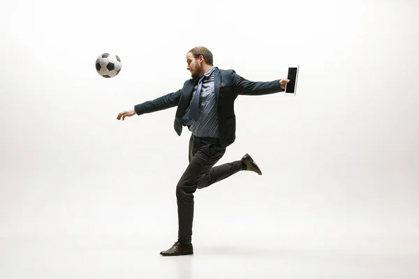 Businessman with football ball in office