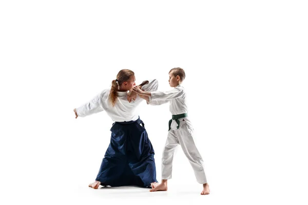 Man and teen boy fighting at aikido training in martial arts school — Stock Photo, Image