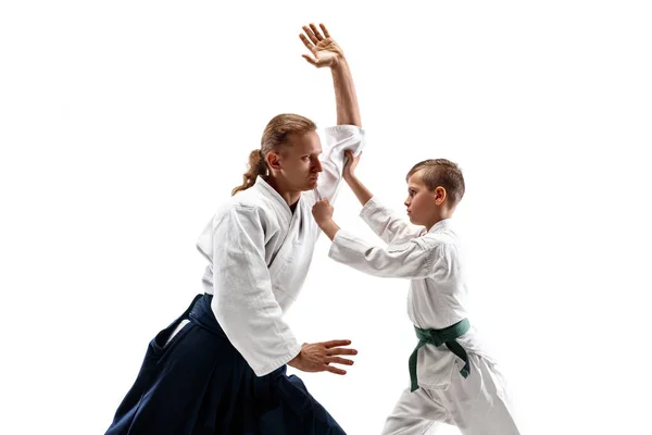 Man and teen boy fighting at aikido training in martial arts school