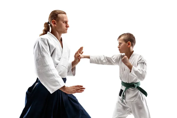 Man and teen boy fighting at aikido training in martial arts school — Stock Photo, Image