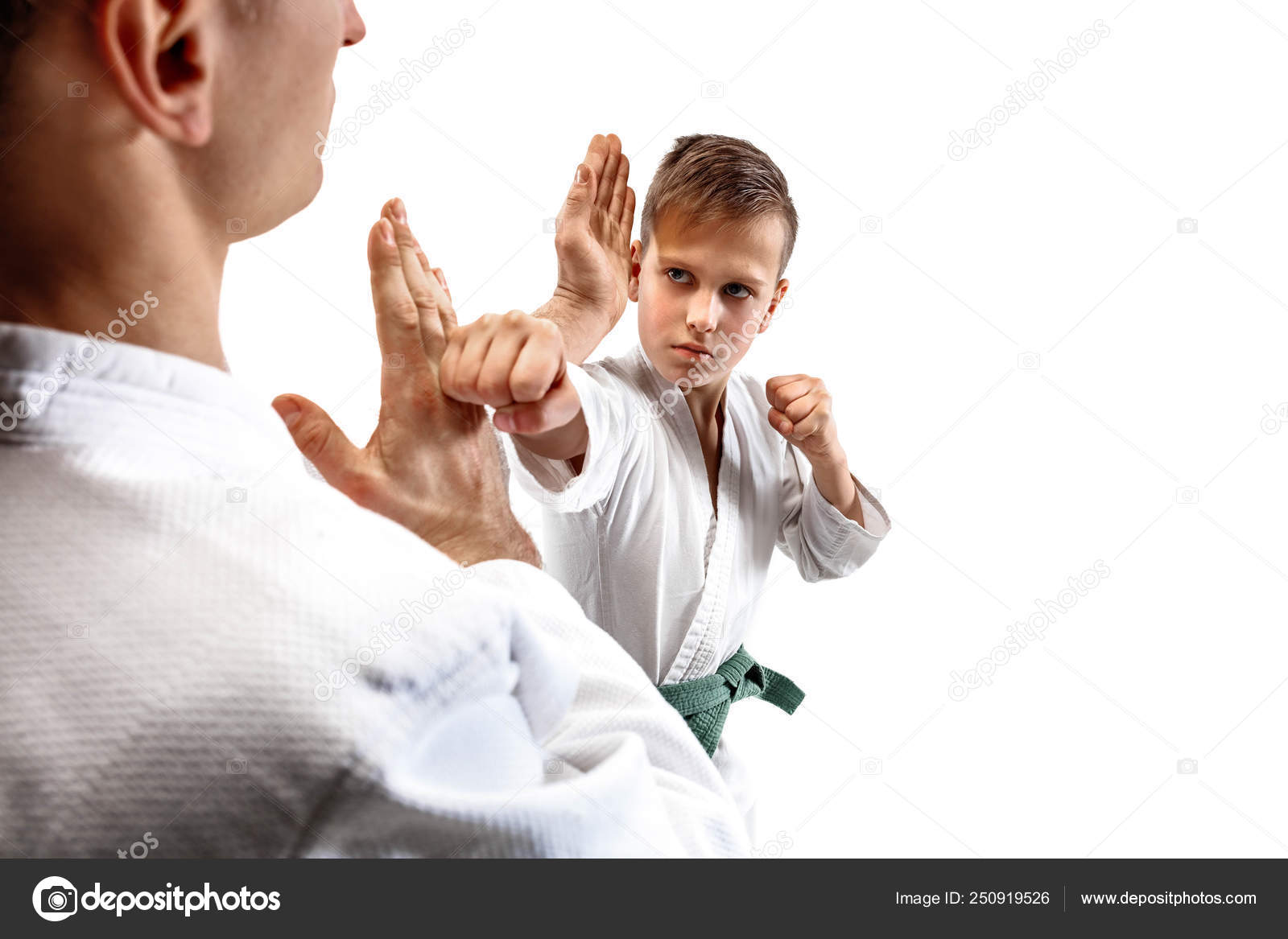 Man and teen boy fighting at aikido training in martial arts school ...