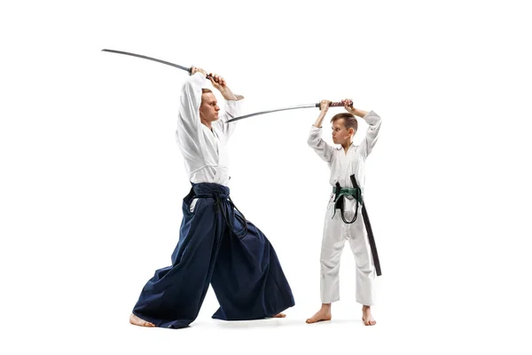 Man and teen boy fighting at aikido training in martial arts school — Stock Photo, Image