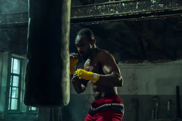 Hand of boxer over black background. Strength, attack and motion concept — Stock Photo, Image