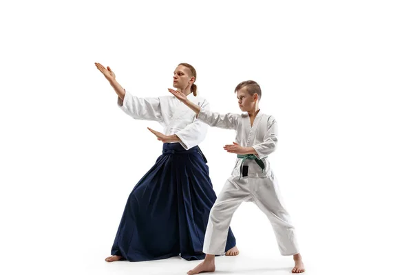 Man and teen boy fighting at aikido training in martial arts school