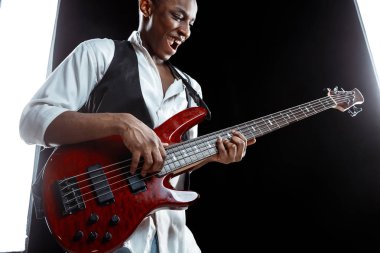 African American jazz musician playing bass guitar. clipart