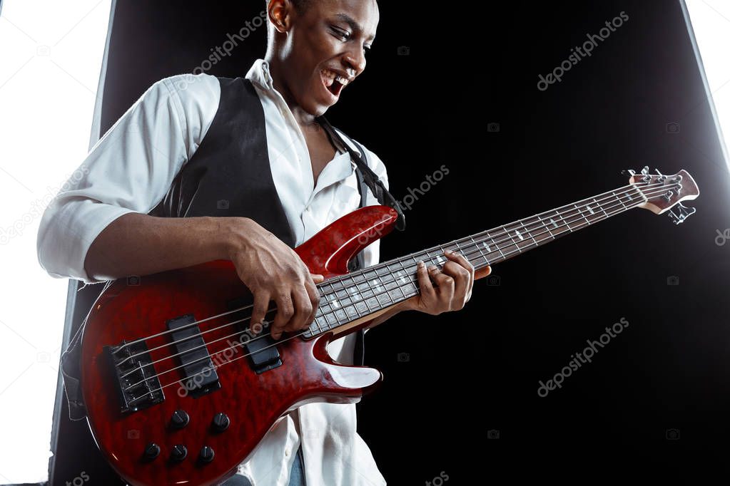 African American jazz musician playing bass guitar.