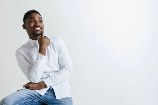 Close up portrait of a happy young african american man laughing against gray background. — Stock Photo, Image