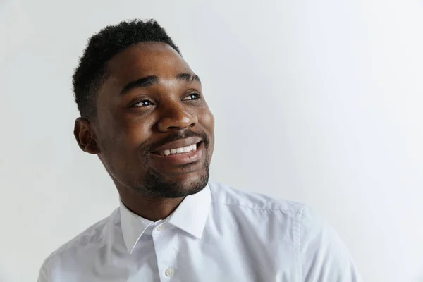 Close up portrait of a happy young african american man laughing against gray background. — Stock Photo, Image