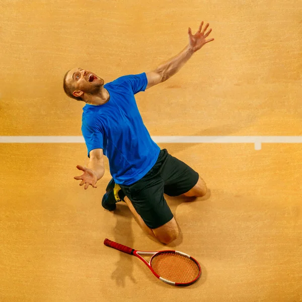 Retrato de un guapo jugador de tenis que celebra su éxito en la corte — Foto de Stock