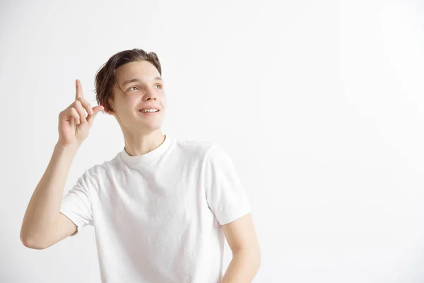 Den lyckliga studenten stående och leende mot grå bakgrund. — Stockfoto