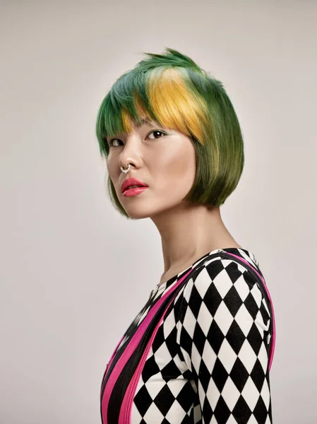 Close-up indoor portrait of lovely girl with colorful hair. Studio shot of graceful young woman with short haircut — Stock Photo, Image