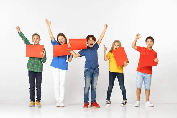 Group of children with red banners isolated in white — Stock Photo, Image