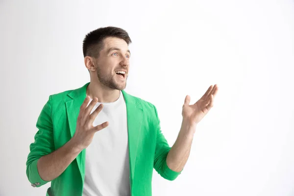 The happy businessman standing and smiling against gray background. — Stock Photo, Image