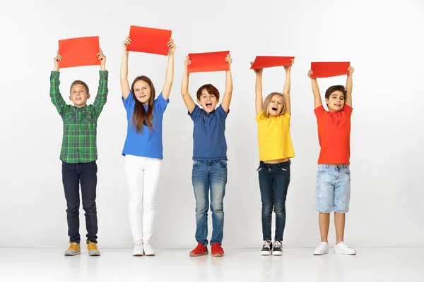 Gruppo di bambini con striscioni rossi isolati in bianco — Foto Stock