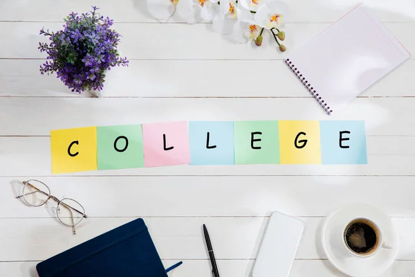 Stationery and word COLLEGE made of letters on wooden background — Stock Photo, Image