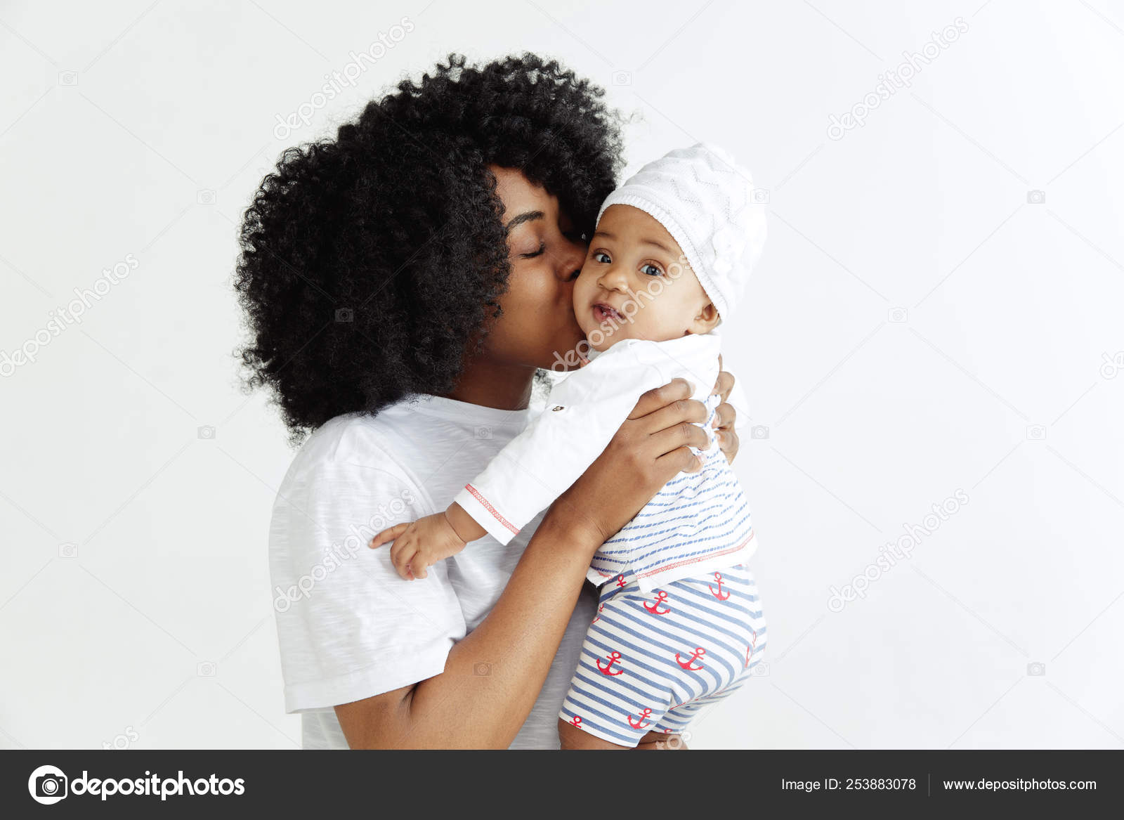 Portrait of beautiful african woman holding on hands her little ...