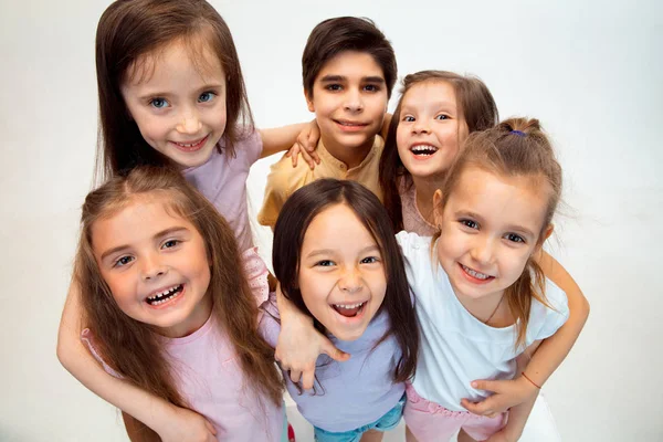 The portrait of cute little boy and girls in stylish clothes looking at camera at studio — Stock Photo, Image