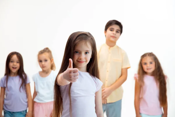 Das Porträt süßer kleiner Jungen und Mädchen in stylischer Kleidung, die im Studio in die Kamera schauen — Stockfoto