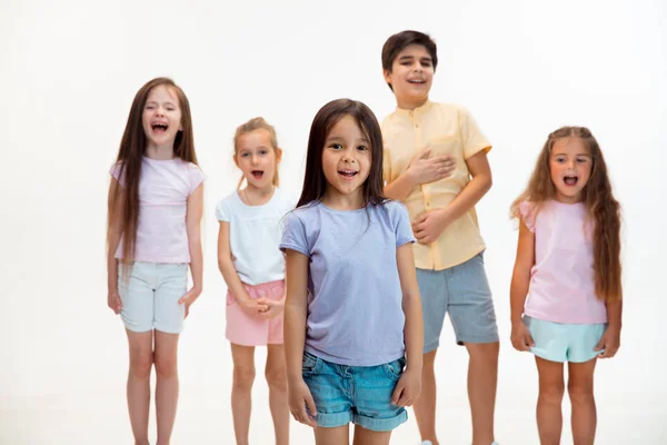 The portrait of cute little boys and girls in stylish clothes looking at camera at studio — Stock Photo, Image