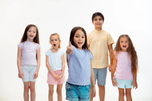 The portrait of cute little boys and girls in stylish clothes looking at camera at studio — Stock Photo, Image