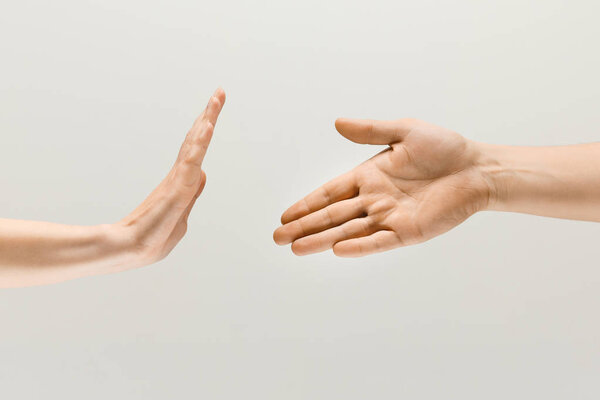 Two male hands isolated on grey studio background