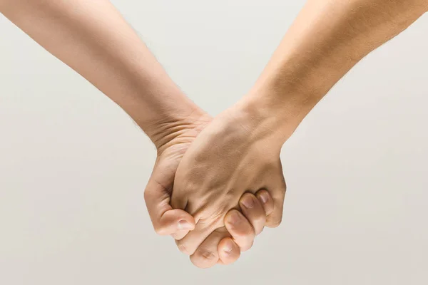 Loseup shot of male holding hands isolated on grey studio background. — Stock Photo, Image