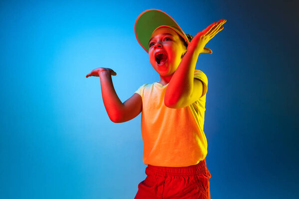 Beautiful teen girl looking suprised isolated on blue