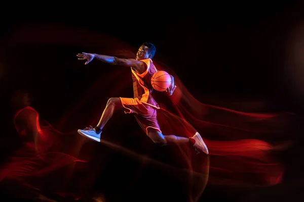 Young basketball player against dark background — 스톡 사진