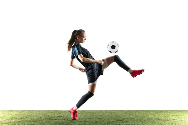 Female soccer player kicking ball isolated over white background — Stock Photo, Image