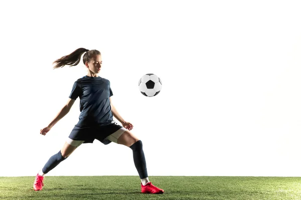 Female soccer player kicking ball isolated over white background — Stock Photo, Image