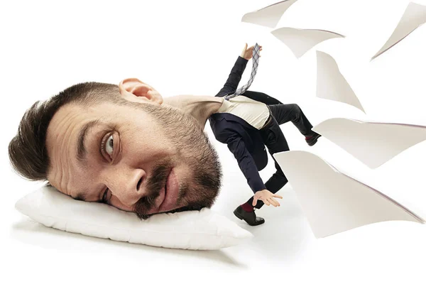 Big head on small body lying on the pillow — Stock Photo, Image