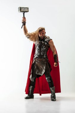 Man in cosplaying Thor isolated on white studio background clipart