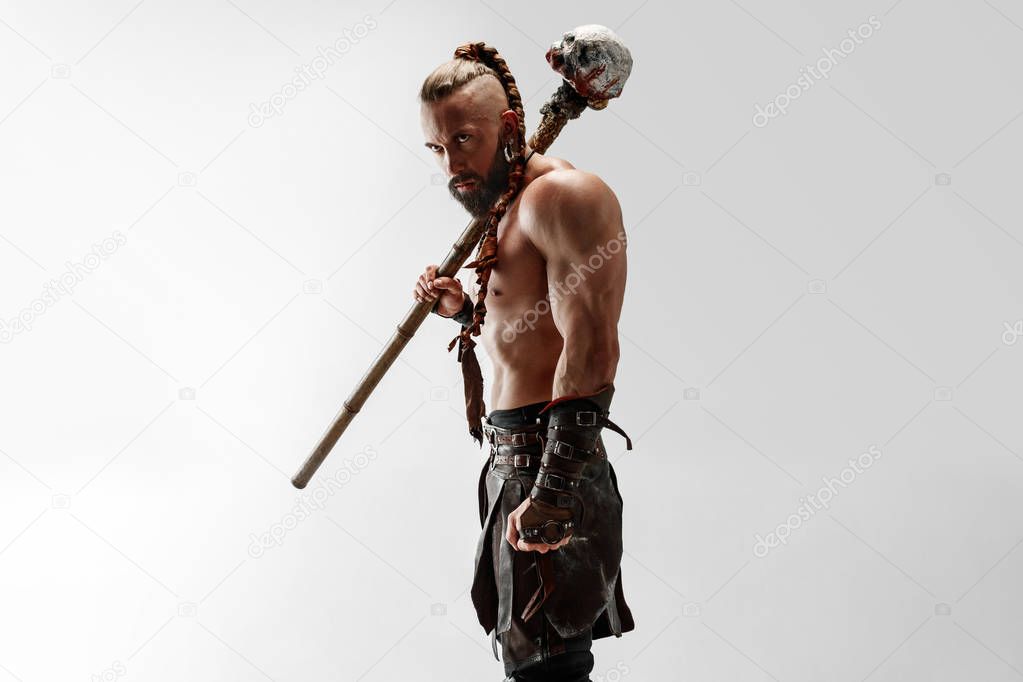 Man in leather vikings costume isolated on white studio background